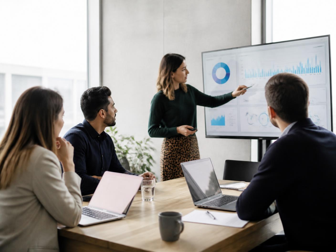 Marketing team reviewing performance dashboards in a meeting room